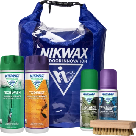 The Nikwax Complete Outdoor Protection Kit, 4 bottles of Nikwax products for outdoor clothing and footwear, a shoe brush and a blue drybag with the Nikwax logo. 